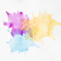 Colourful hand painted stains on white surface