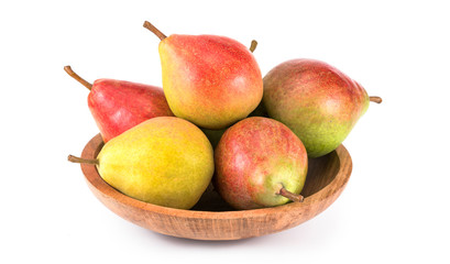 Fresh pears on the wooden plate. On white background