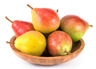 Fresh pears on the wooden plate. On white background