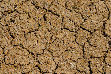 Desert dried and cracked ground. erosion earth background. cracked dry wall surface. white natural...