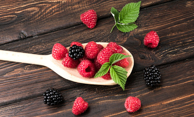 raspberries and blackberries in a wooden spoon