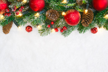 Christmas decoration garland of fir branches, red balls and lamps
