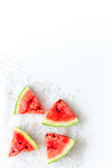 Cut watermelon on stick for break with fruit popsicle on white background top view mockup