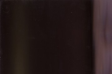 Dusty filmstrip. Brown filter overlay. Blur glow on dark background.
