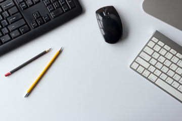 business concept. top view of office desk workspace with desktop computer, pen, keyboard, glasses and hot on white table background