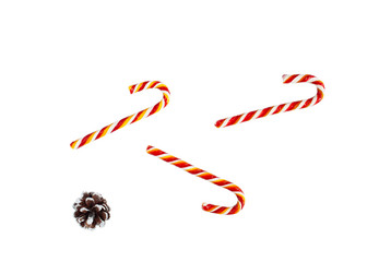 Christmas composition. Candy canes with cone on white  background