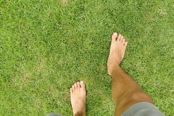 bare foots walking on green grass