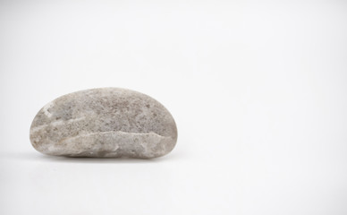 Fototapeta na wymiar Picture of a single stone in the natural shape on a white area