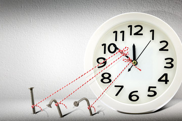 Stop time on clock by rope and nail.Business management and control for period and break overtime...