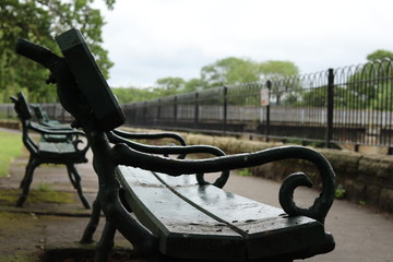 A wet bench beside a river in Otley, Yorkshire 