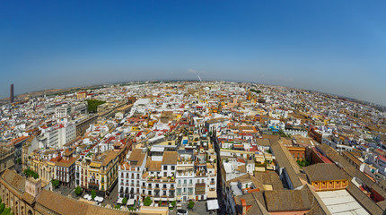 Naklejka premium Panoramic view of Seville from the height of the Giralda tower of Cathedral on a sunny day.