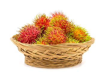 Fototapeta premium Close up fresh rambutan sweet and delicious fruit in basket isolated on white background.