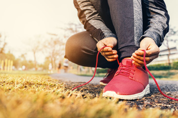 Woman tying running shoes laces