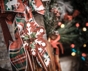 Decorative christmas bow and background decorations and lights outdoors