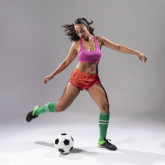 Fototapeta na wymiar Adult woman playing football