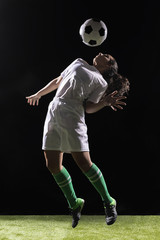 Beautiful woman playing with soccer ball