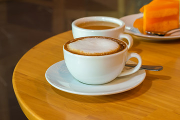 cup of coffee on wooden table