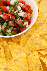 Pico de Gallo with gluten free tortilla chips, side view. Close-up.