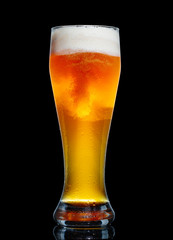 Glass of beer isolated on black background.