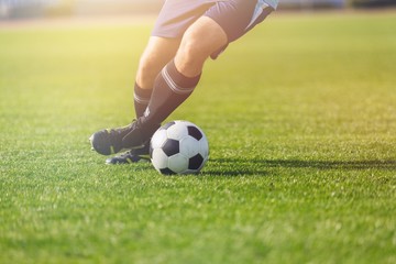Running soccer player on grass