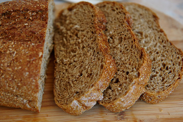 rye bread sliced for sandwiches on a wooden board