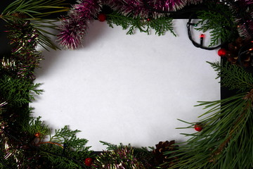 Frame of coniferous branches, cones, Holly berries with space for congratulations. The concept of...