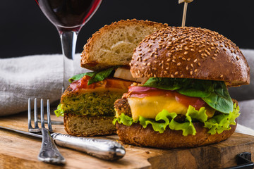 Vegetarian Burger with fries and drink on wooden table