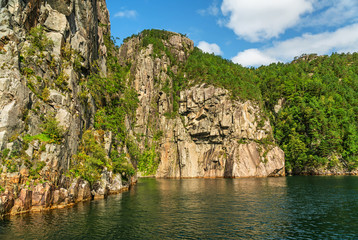 Fototapeta na wymiar Lysefjord forested mountain rock landscape, fjord sea view, Norway.