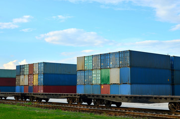 Obraz premium Cargo dock terminal with sea containers. logistic warehouse port of shipping container for the subsequent sorting, loading and sending them on freight railway cars or trucks to the client - Image