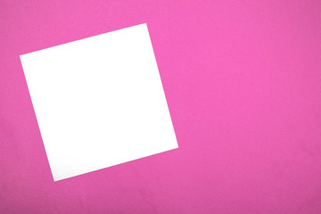 White sheet for writing on a pink background.