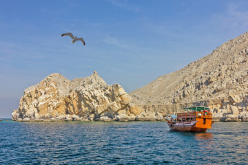 Boat in Oman fjords, mountain sea landscape view, Khasab