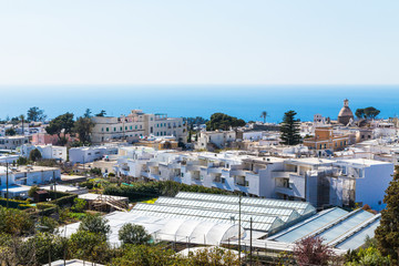 Fototapeta na wymiar View of Capri city, Italy with white houses and blue water.