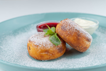 Cottage cheese pancakes with sour cream and berry jam isolated on white flat lay