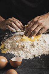 Close-up hand mixing flour and yolk