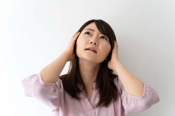 Young business woman in trouble against white background