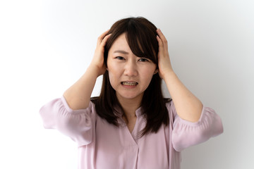 Young business woman in trouble against white background