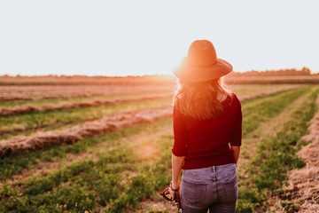 beautiful caucasian woman watching sunset in countryside. Relax and lifestyle outdoors