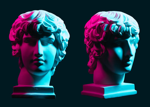 Statue neon. On a blue isolated background. Gypsum statue of Antinous head. Man.
