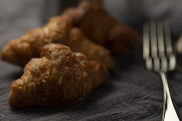 coffee maker and croissants on wooden table