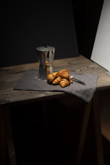 Obraz na płótnie Canvas coffee maker and croissants on wooden table