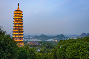 Bai Dinh Pagoda at twilight, Ninh Binh, the biggest buddhist temple complex in Vietnam, tourist religious travel destination. Scenic karst landscape.