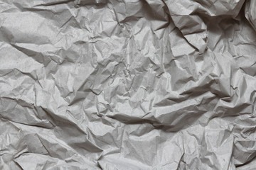 Crumpled gray craft paper texture background. Package wrapping. Old wrapping paper. Baking parchment. Letter template.