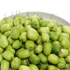 mini kiwi baby fruit (actinidia arguta) on white background 
