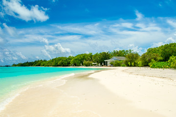 Beautiful sandy beach and over water tropical bungalo