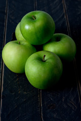 Close up green apple on wooden table background