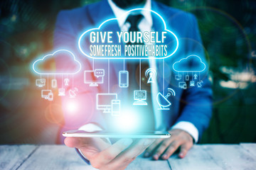Fototapeta premium Conceptual hand writing showing Give Yourself Some Fresh Positive Habits. Concept meaning Get healthy positive routines Male wear formal work suit presenting presentation smart device