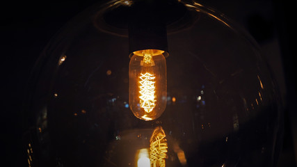 Closeup of wire style LED bulb with orange illumination. Selected focus.