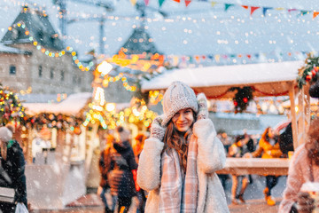 Girl walking on Christmas Market on Red Square in Moscow