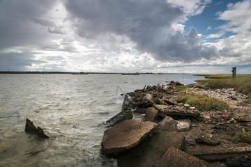 Angry dark clouds gathering over Harty Ferry and The Swale on the Isle of Sheppy, Kent, England