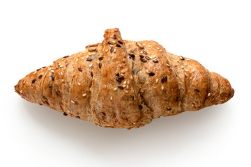 Whole wheat croissant with linseeds and sesame seeds isolated on white. Top view.